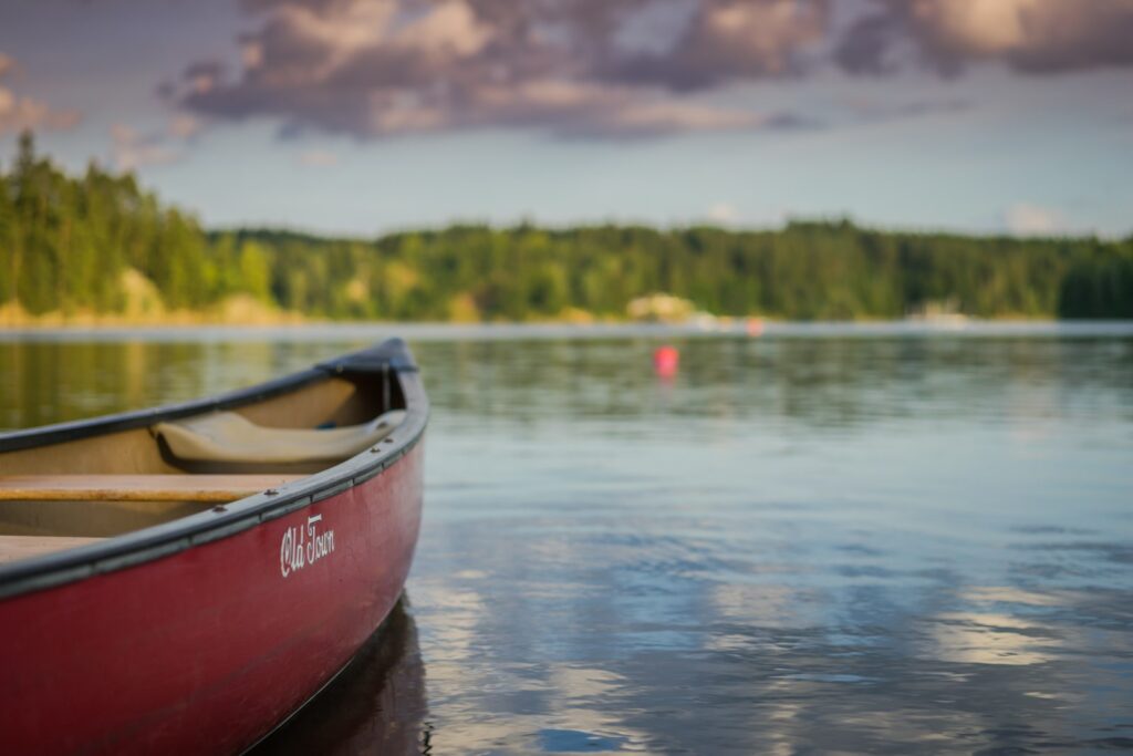 Red canoe on a calm lake